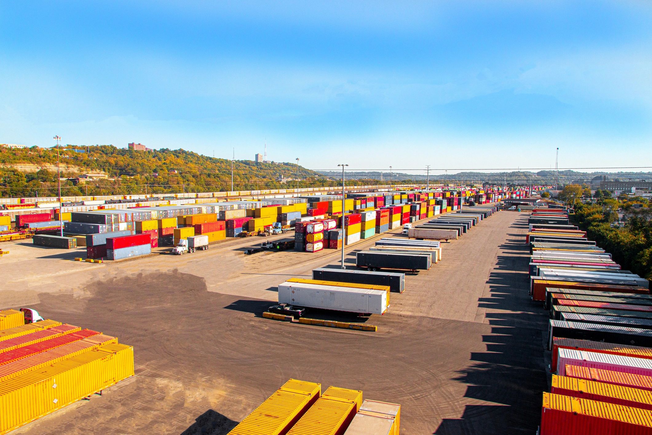 Shipping yard with box containers and semi-truck trailers