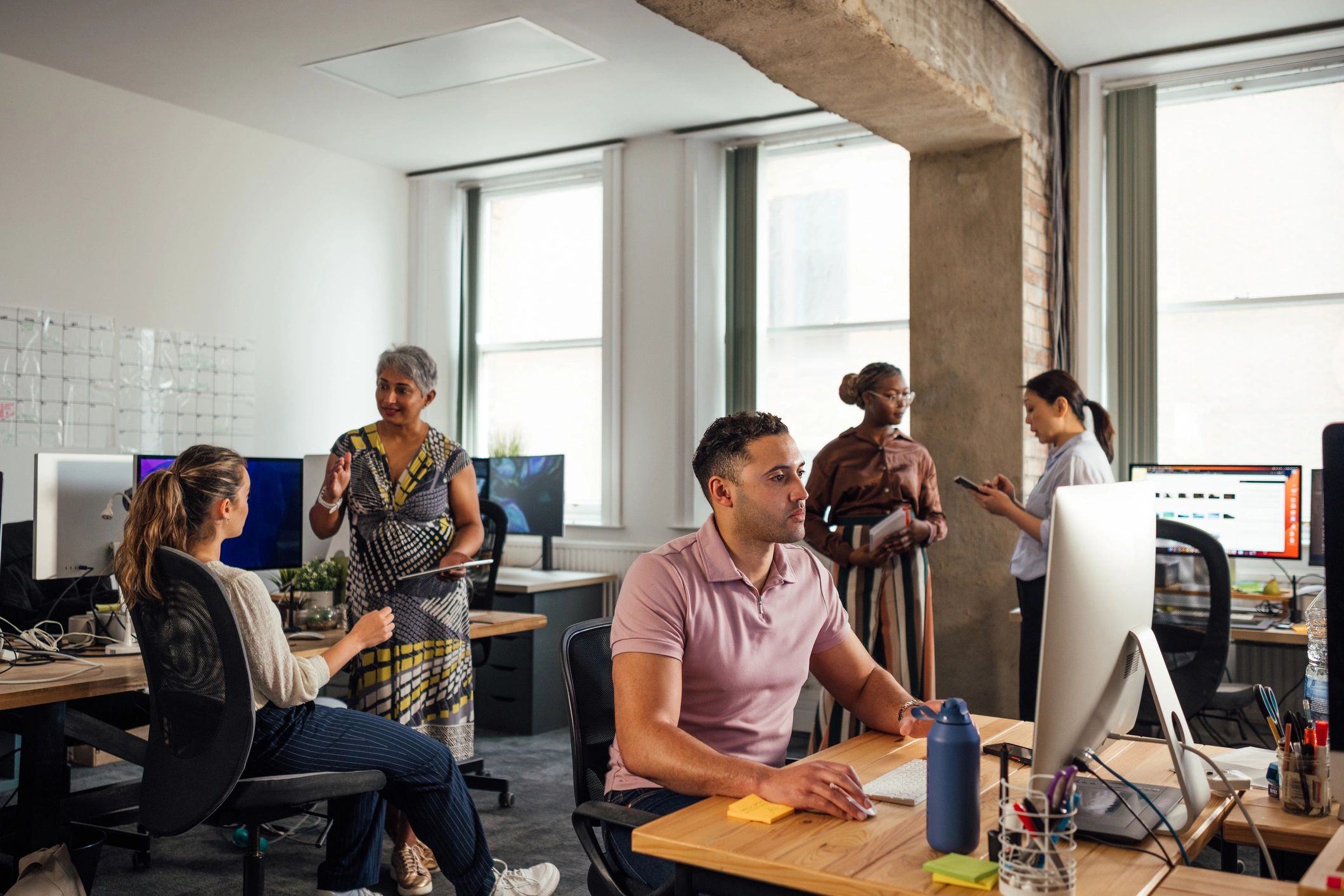 Professionals working together in a technology-focused office