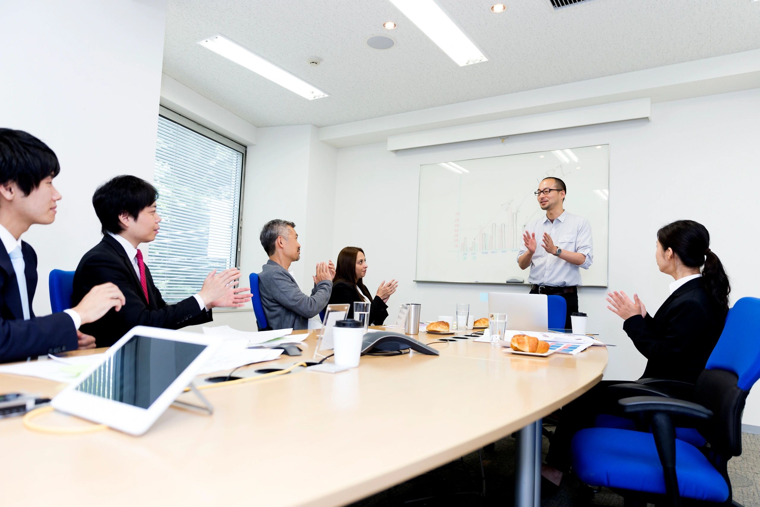 Procurement professional presenting to colleagues